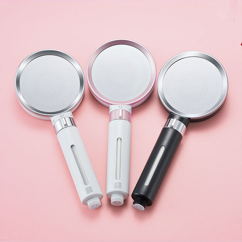 Three handheld shower heads with different handle colors.