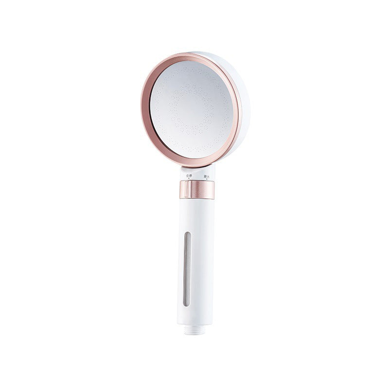 Handheld mirror with rose gold frame and white base.